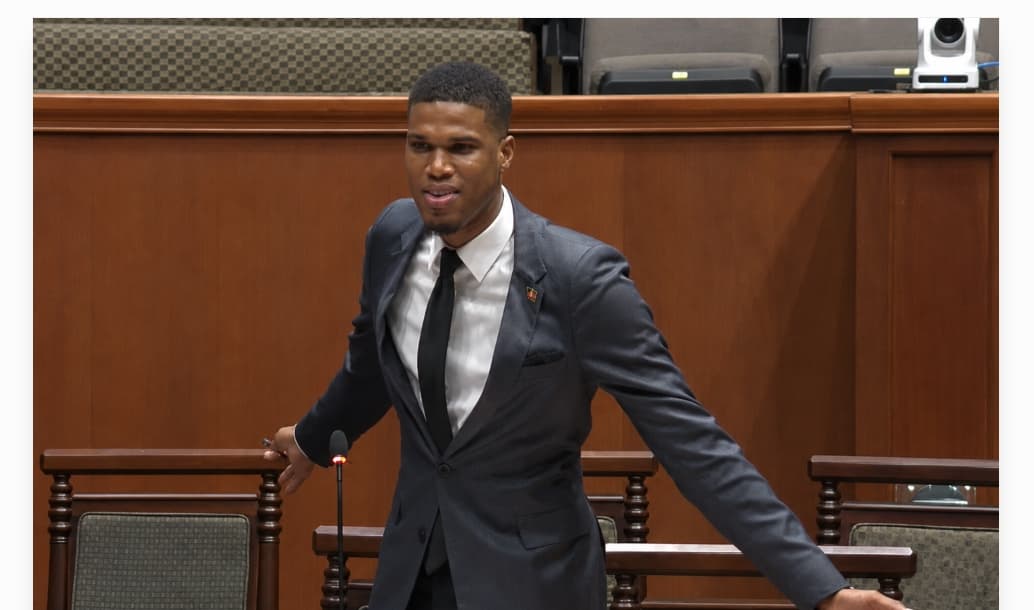 jonathan wehner arms outstretched speaking in parliament